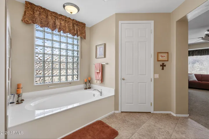 A private toilet room is next to the soaking tub.