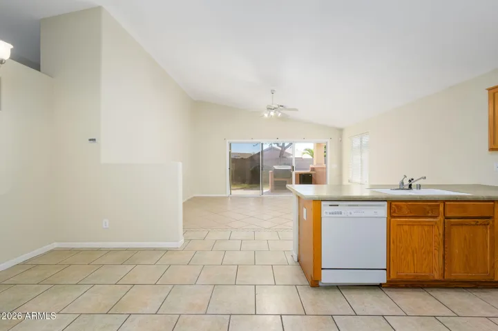 View from Front Door/Living Room shows off vaulted ceilings and dining room space.
