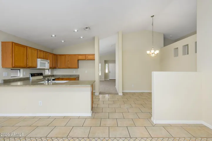 This view from back patio door features the dedicated dining space off kitchen towards living room and front door.