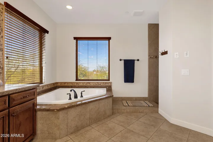 Jetted soaking tub, adjacent to walk in shower.