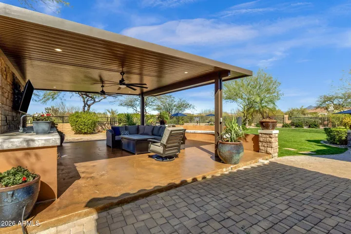 Enjoy alfresco dining on your newly stained concrete patio with outdoor kitchen.