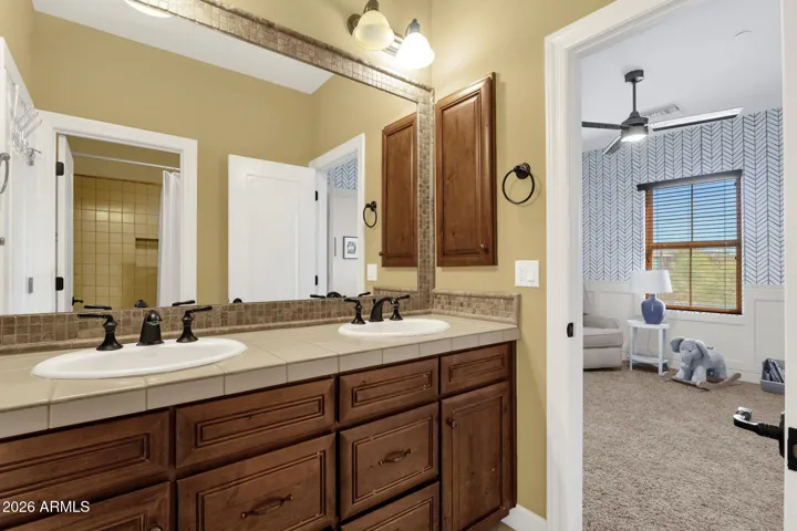Jack and Jill bathroom with double vanities, shower and tub.