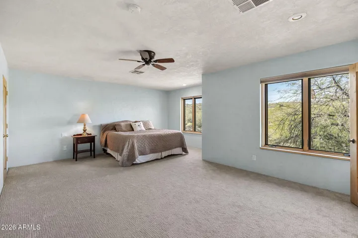 Additional perspective of the primary suite highlighting natural light and spacious layout.