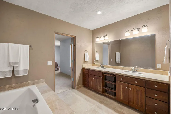 Relaxing primary bath complete with a soaking tub and dual sinks.