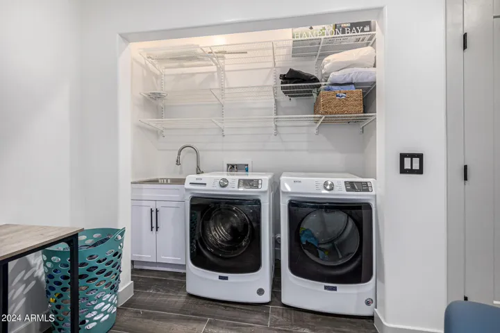 Basement laundry room with sink.