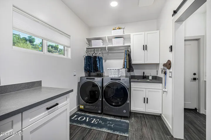 Main floor laundry room with sink.