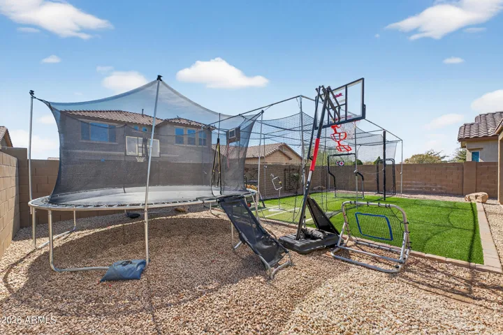 Large Backyard with Covered Patio, Artificial Grass, and Mister System.