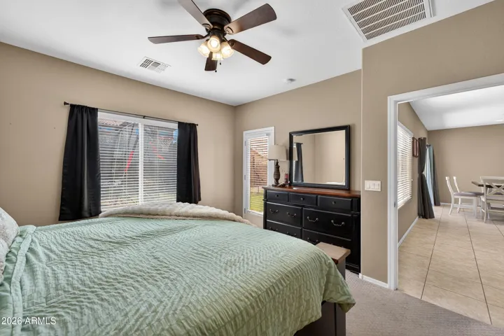 Downstairs Primary Bedroom Measures 14'x14'3" and has an Exit Door that leads to the Patio.