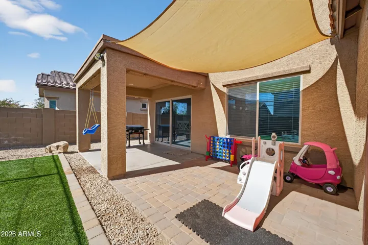 Large Backyard with Covered Patio, Artificial Grass, and Mister System.