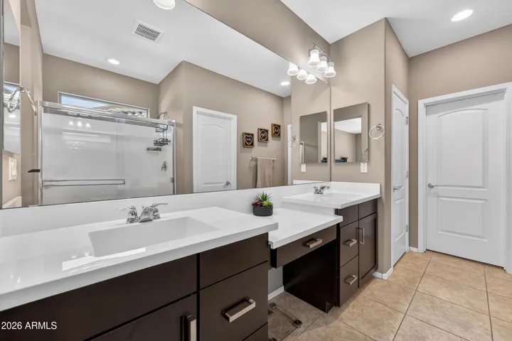 En Suite has Large W.I.C., Linen Closet, Walk-In Shower, and Dual Sink Vanity with Makeup Counter.