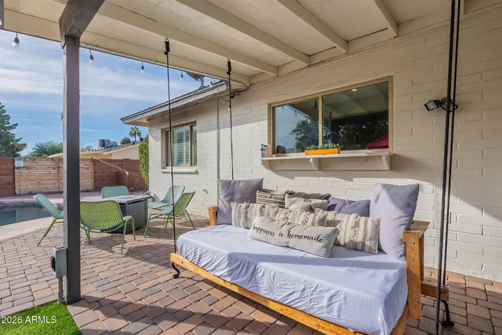 Enjoy a swing on the daybed under the covered patio