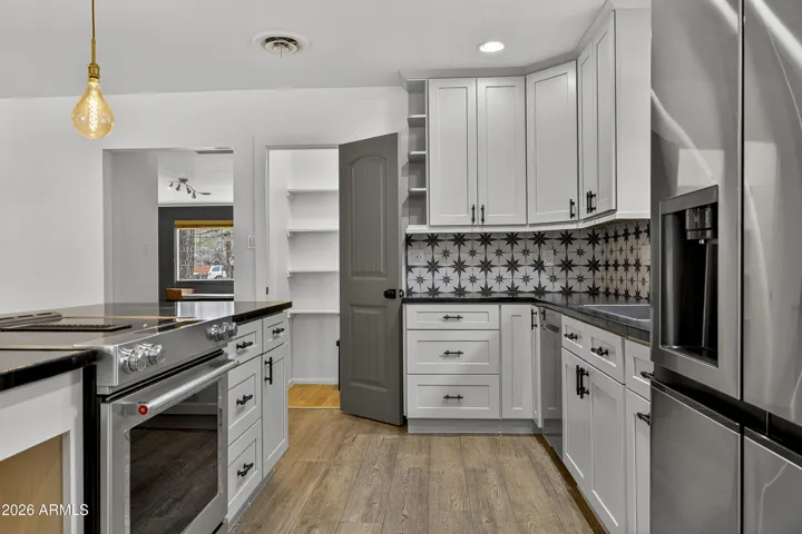 Functional kitchen layout with ample counter space and stylish pendant lighting.