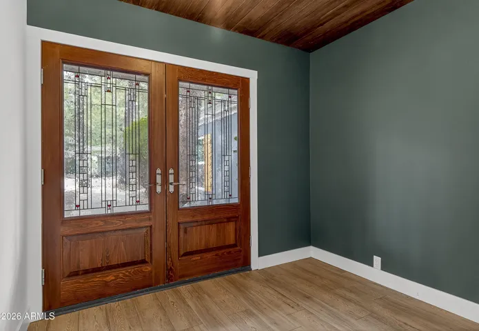 Charming glass-paneled double doors that flood the entry with natural light.