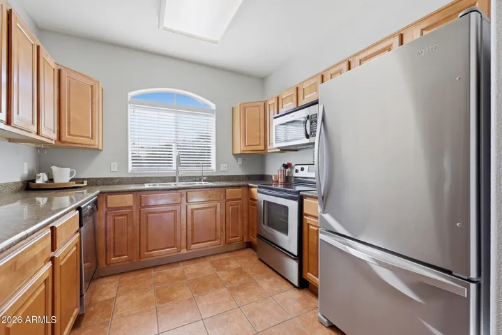 Featuring granite countertops and ample cabinetry