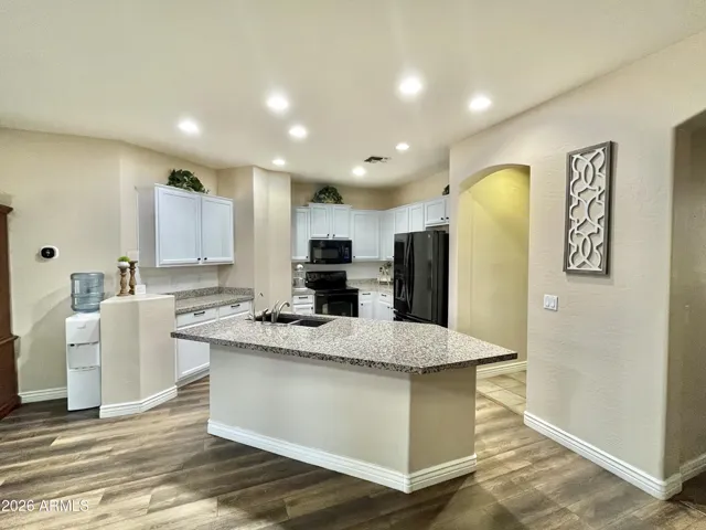 bright white cabinets, white subway tile backsplash and black pulls and knobs