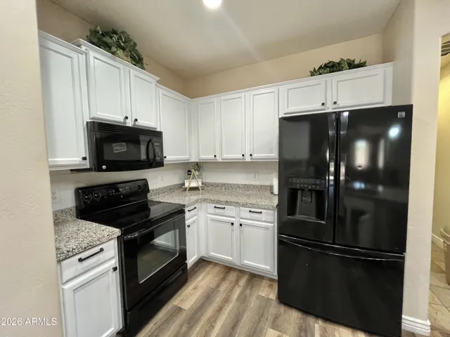 bright white cabinets, white subway tile backsplash and black pulls and knobs