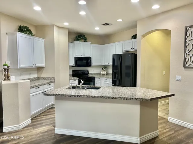 bright white cabinets, white subway tile backsplash and black pulls and knobs