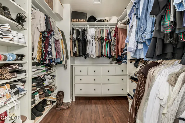Custom walk-in-closet in the primary suite with built in storage and organization