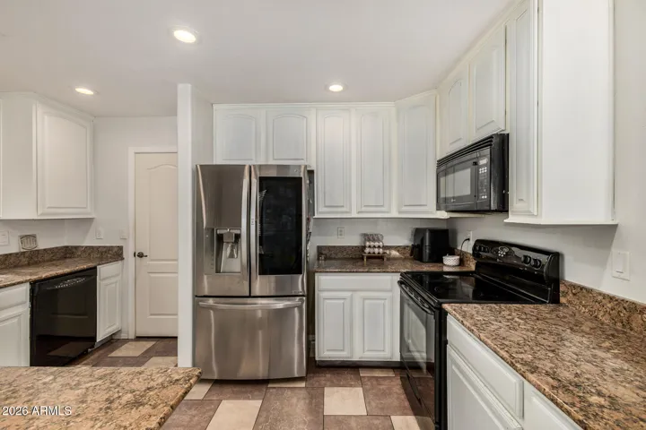 Upgraded kitchen with bright white cabinets and granite countertops. Perfect for cooking and entertaining