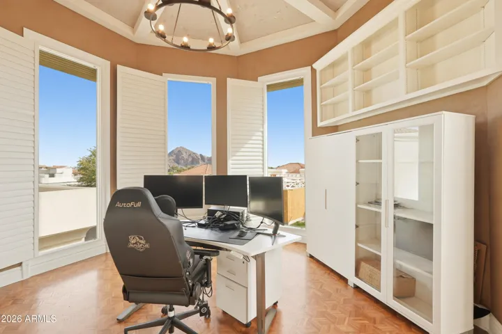 Home office or third bedroom with large windows framing Camelback Mountain.