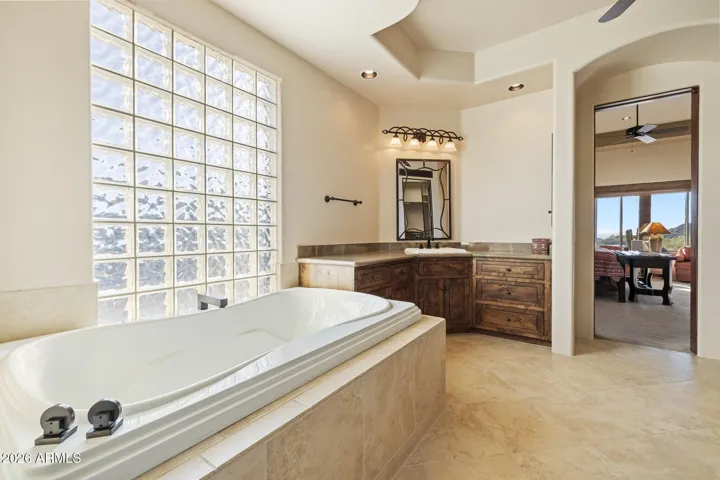 Primary bathroom with jetted tub, walk-in shower, twin vanities and extra large closet with safe.