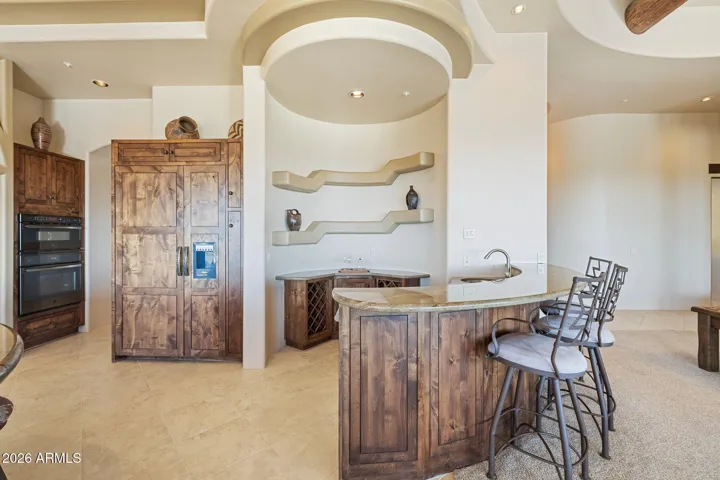 Wet-bar with beverage fridge & ice maker.