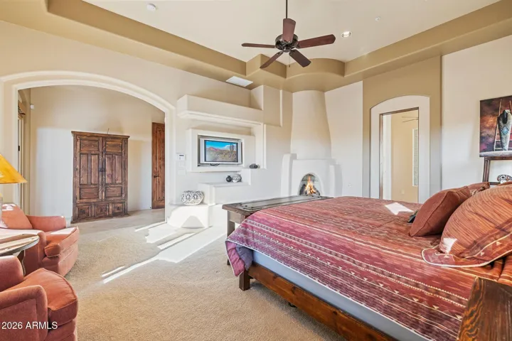 Primary suite with gas fireplace and access to patio.