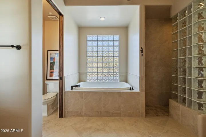Junior suite bathroom with tub, shower, twin vanities and large walk-in closet.