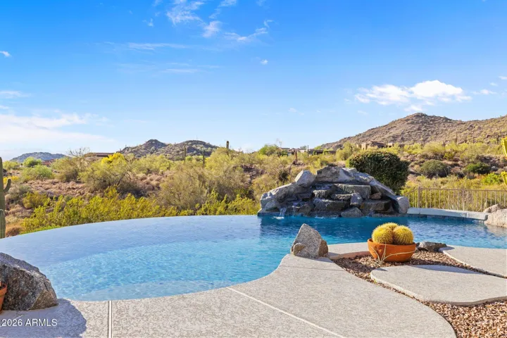 Negative-edge pool with spa and waterfall.