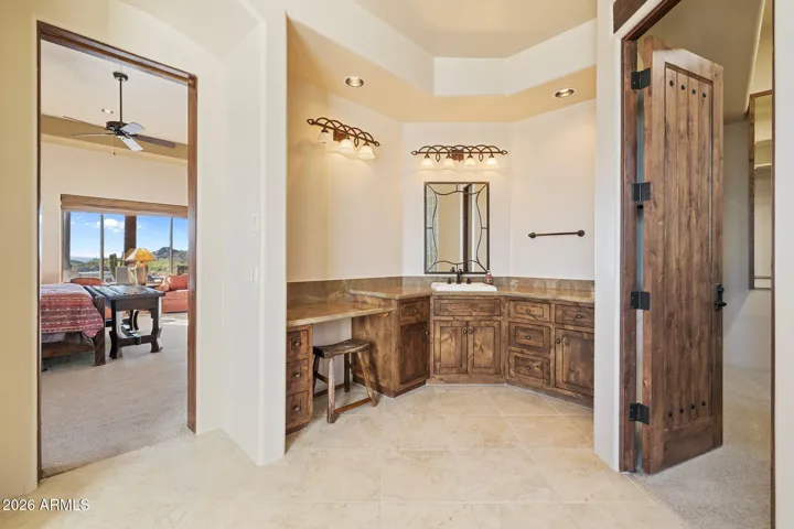 Primary bathroom with jetted tub, walk-in shower, twin vanities and extra large closet with safe.