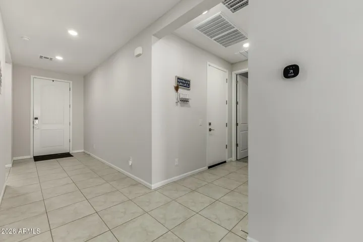 Entry Hallway looking at garage door and "mud room". The entry to bedroom 4 with private ensuite
