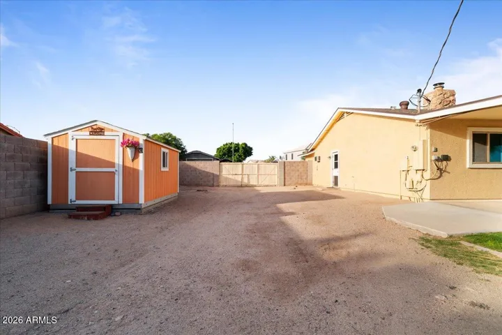 West Side yard with RV Gate and Storage Shed.