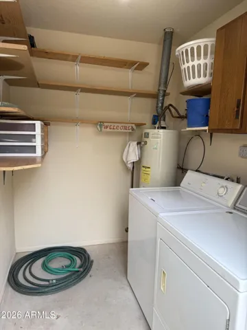 Lots of shelving in the storage shed, gas hot water heater, and washer & dryer