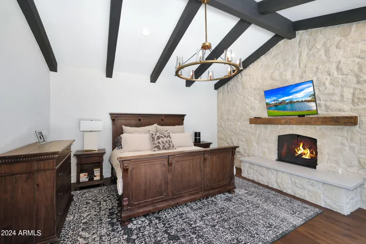 Primary bedroom with gorgeous stone fireplace