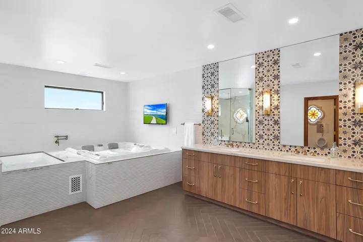 Primary bathroom: cold plunge and spa, beautiful custom tile and double vanity