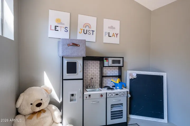 Inside of a shed in the back that has been turned into a playhouse for kids ....
