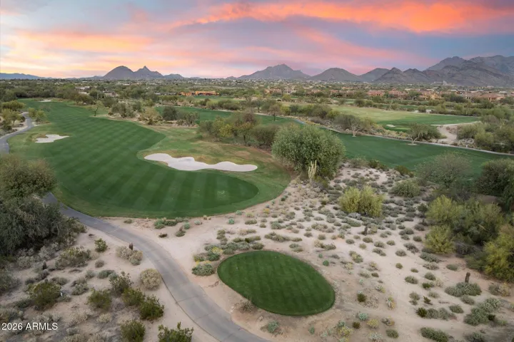 Aerial view of the surrounding golf course and mountains at sunset