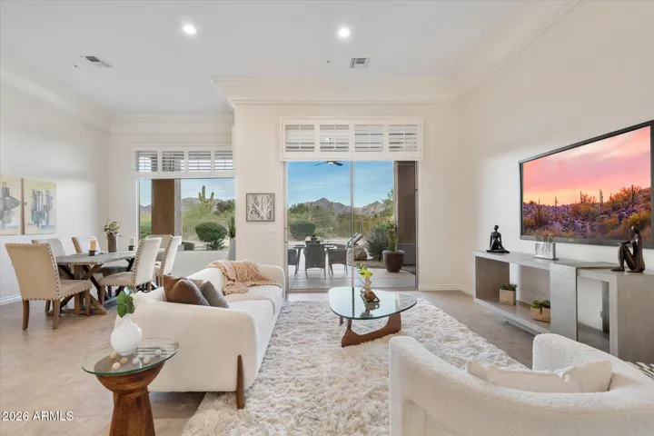 Step inside to the living and dining room with new paint and light fixtures and stunning mountain, desert, and golf course views