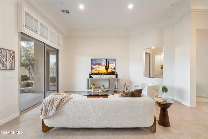 Step inside to the living and dining room with new paint and light fixtures and stunning mountain, desert, and golf course views