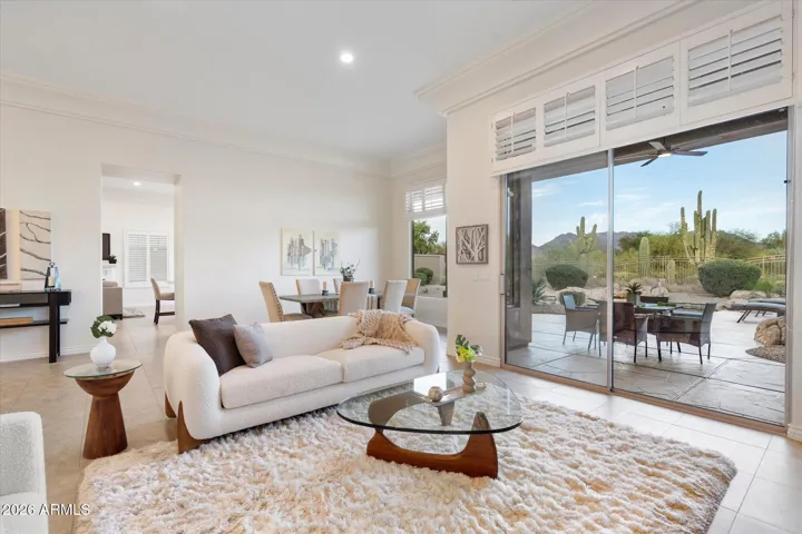 Step inside to the living and dining room with new paint and light fixtures and stunning mountain, desert, and golf course views