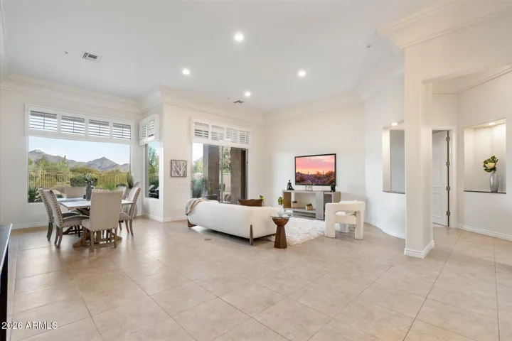 Step inside to the living and dining room with new paint and light fixtures and stunning mountain, desert, and golf course views