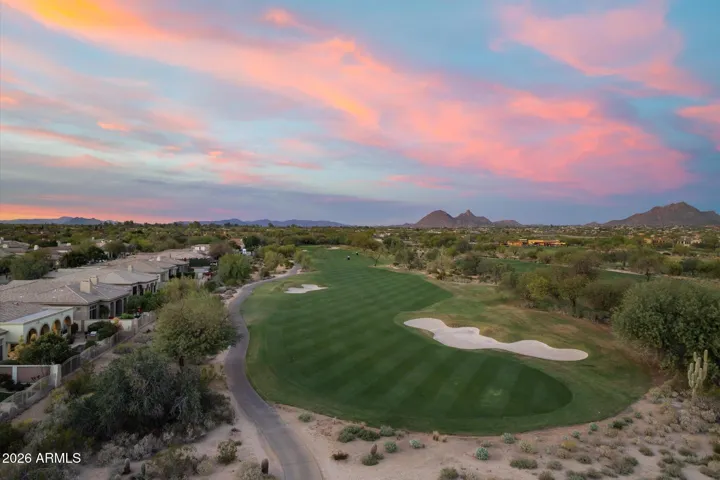 Aerial view of the surrounding golf course and mountains at sunset