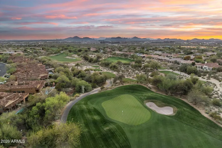 Aerial view of the surrounding golf course and mountains at sunset