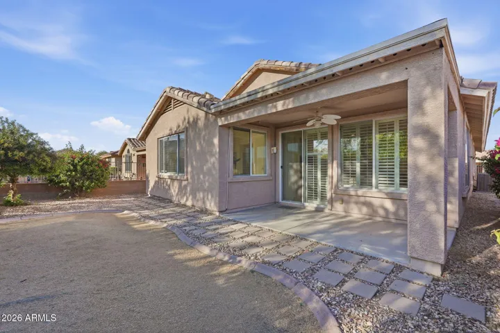 Private fenced in backyard with covered patio