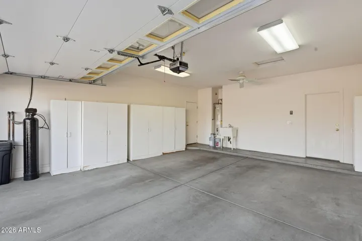 Spacious garage with cabinetry for storage