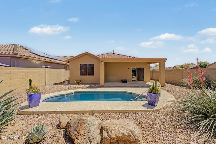 Desert landscaped backyard with a pool.