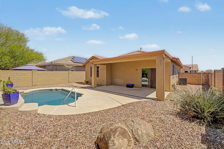 Desert landscaped backyard with a pool.