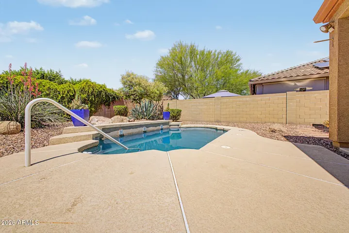 Desert landscaped backyard with a pool.