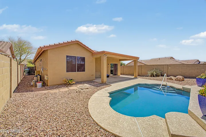 Desert landscaped backyard with a pool.