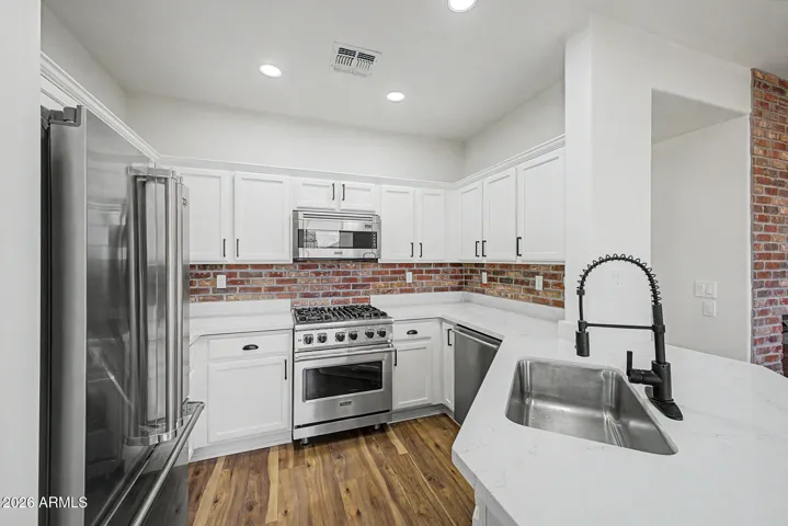 Renovated Kitchen with Viking Appliances including Gas Range, New Quartz Counters, Backsplash & Cabinets!
